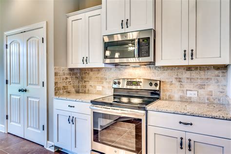 distressed white cabinets with stainless steel countertops|white countertops colors.